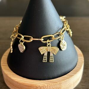 Delicate Gold Charm Bracelet with Bow and Charm Accents
